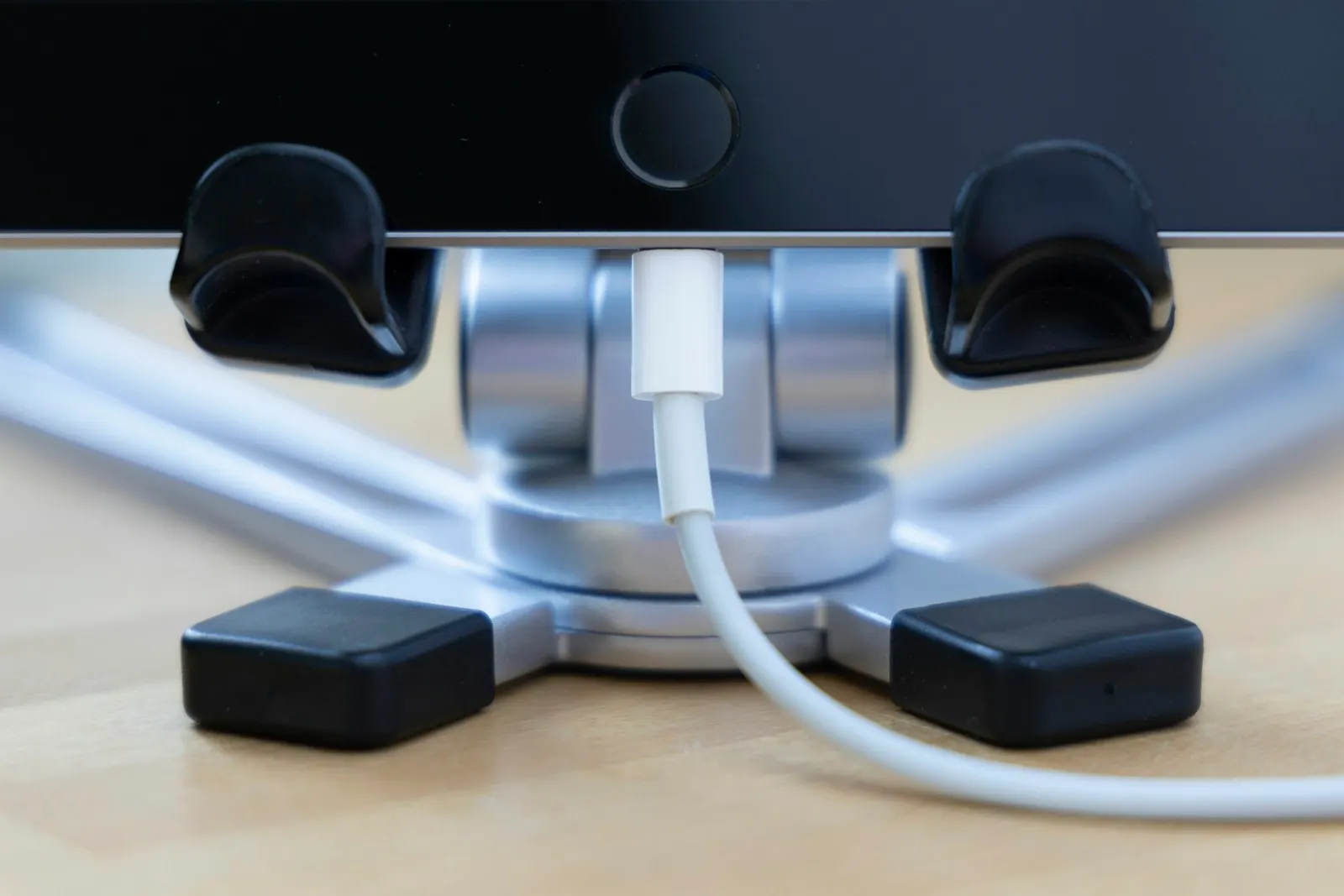 A tablet on a stand with a charging cable connected