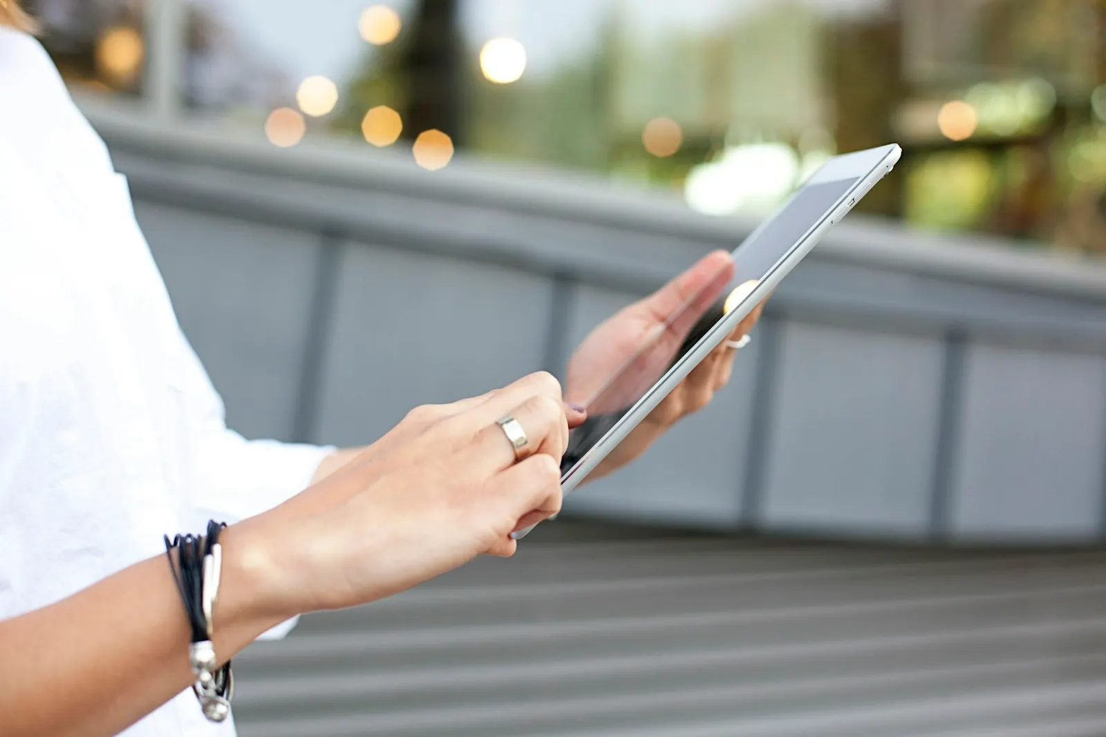 Hands holding an iPad outdoors