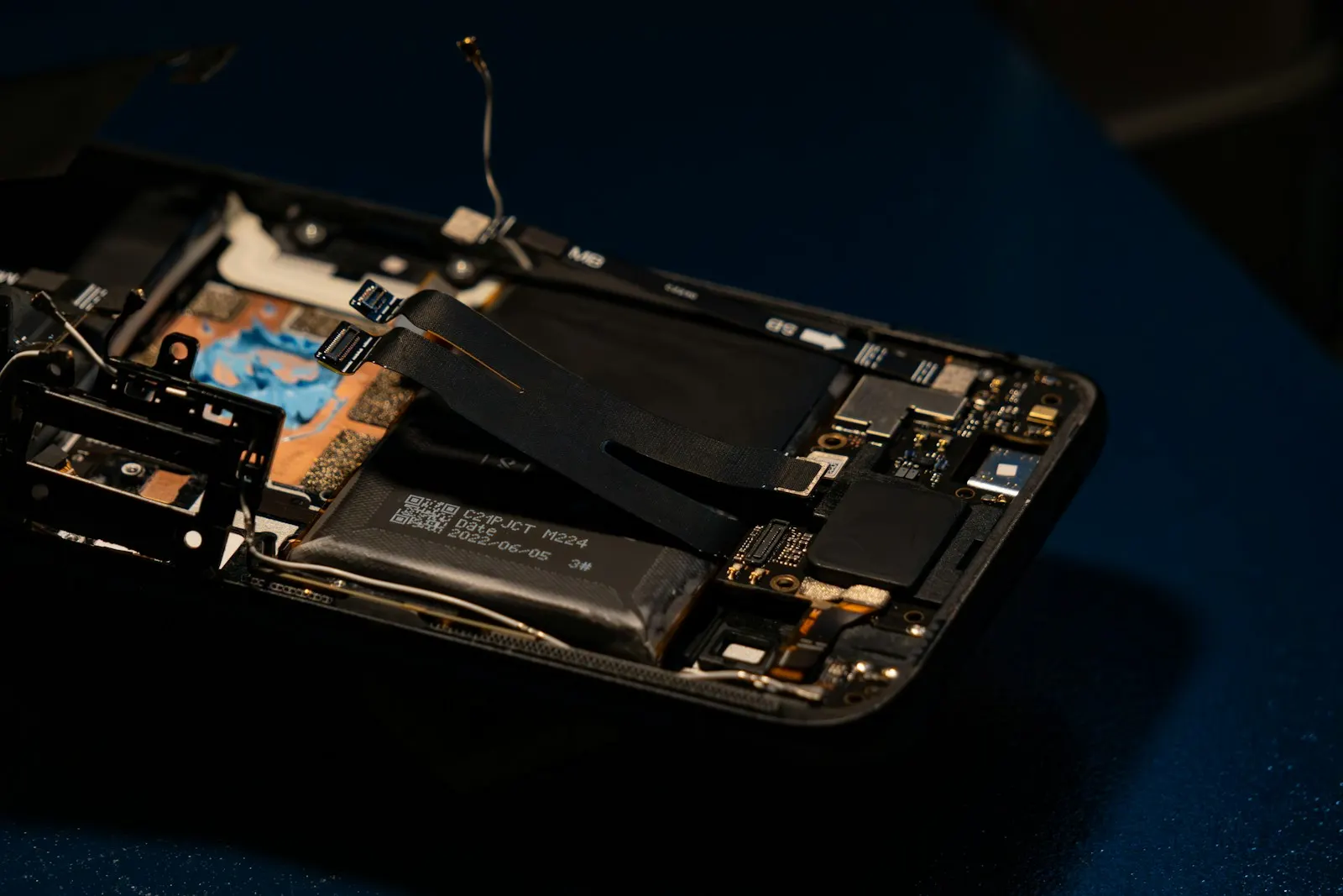 An opened smartphone showing its internal battery and components