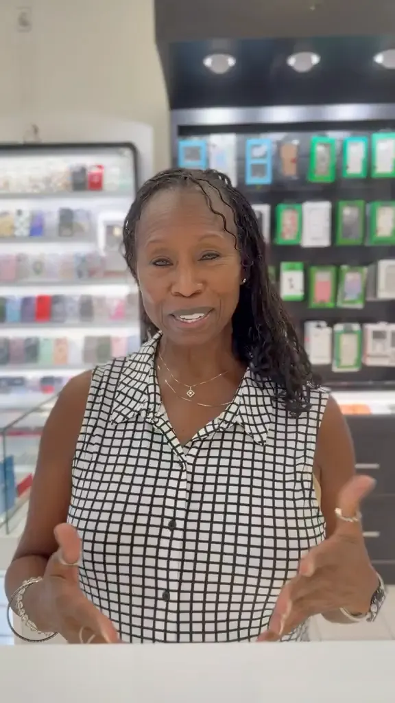 A CELLTECH customer speaking to the camera at the counter of The Parks Mall store