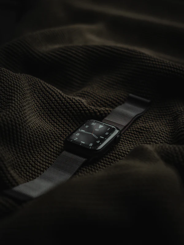 A smartwatch on a wrist, its display lit