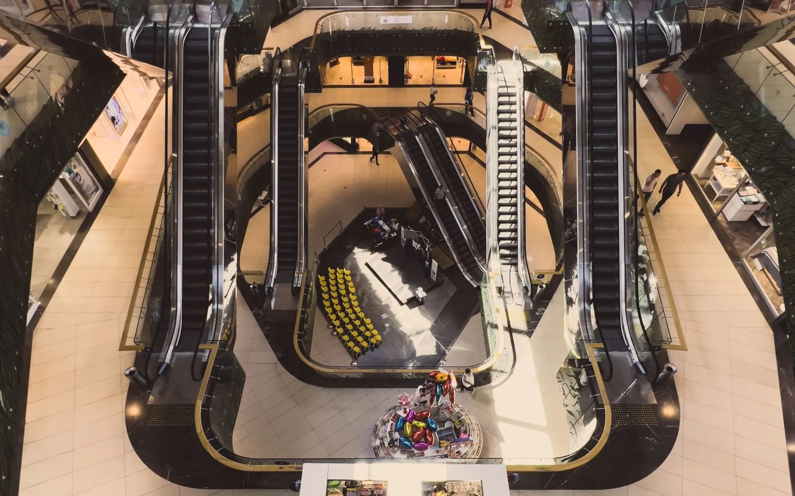 Looking down on the escalators and walkways of a multi-level shopping mall