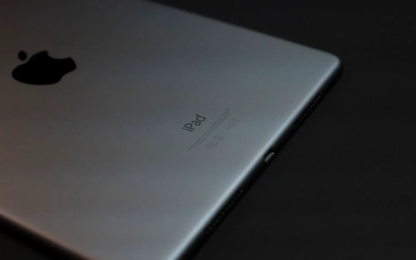 A close-up of an iPad against a dark background