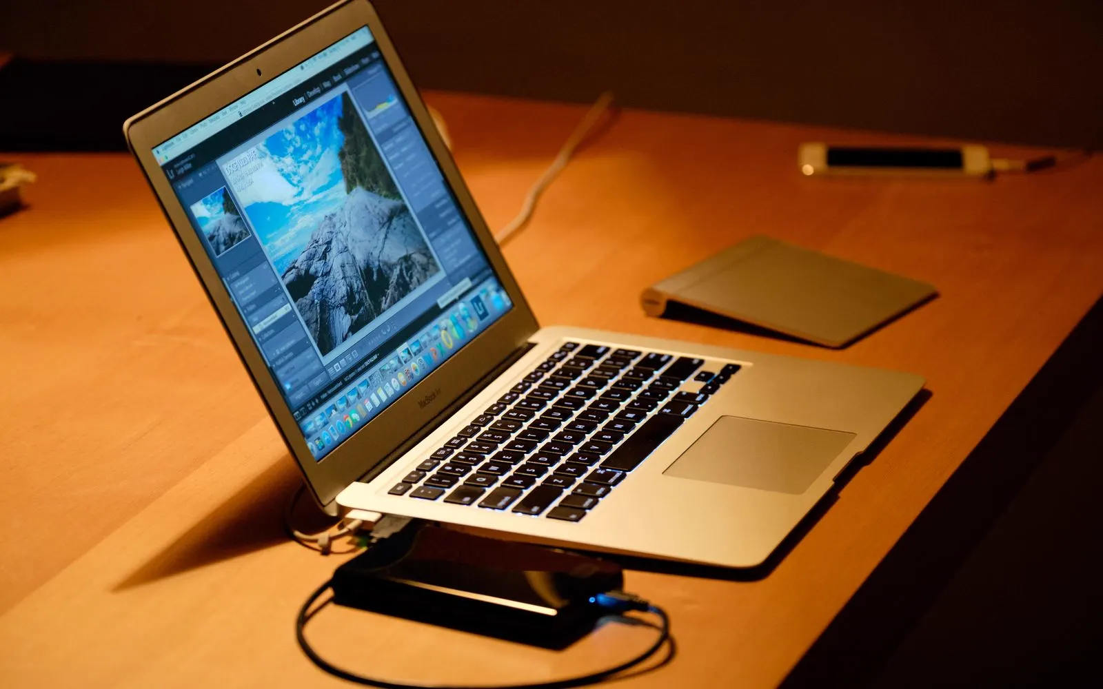 A laptop on a wooden desk in a home office