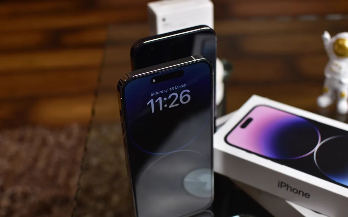 An iPhone on a desk with its display lit