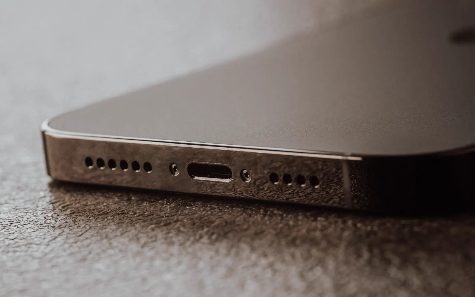 A close-up of the charging port on the bottom edge of a phone