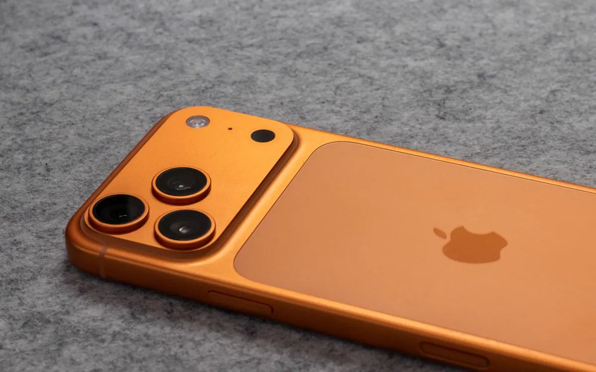 The camera array on the back of an orange iPhone Pro