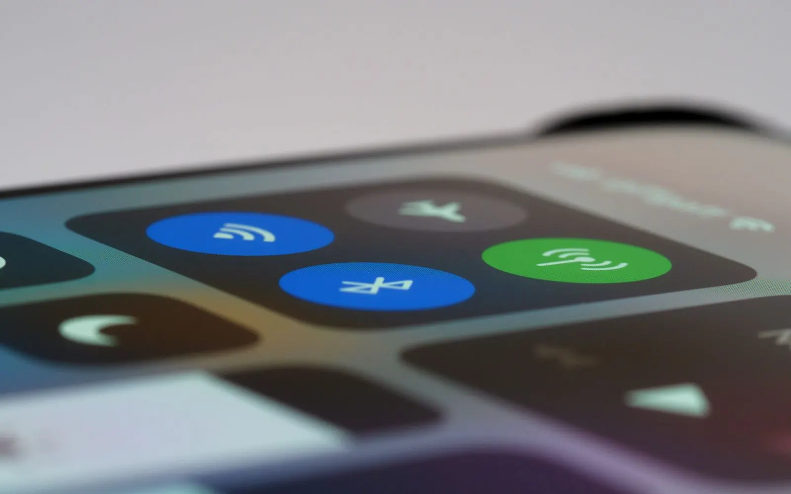 Close-up of an iPhone Control Center with the Wi-Fi, Bluetooth and brightness controls in view