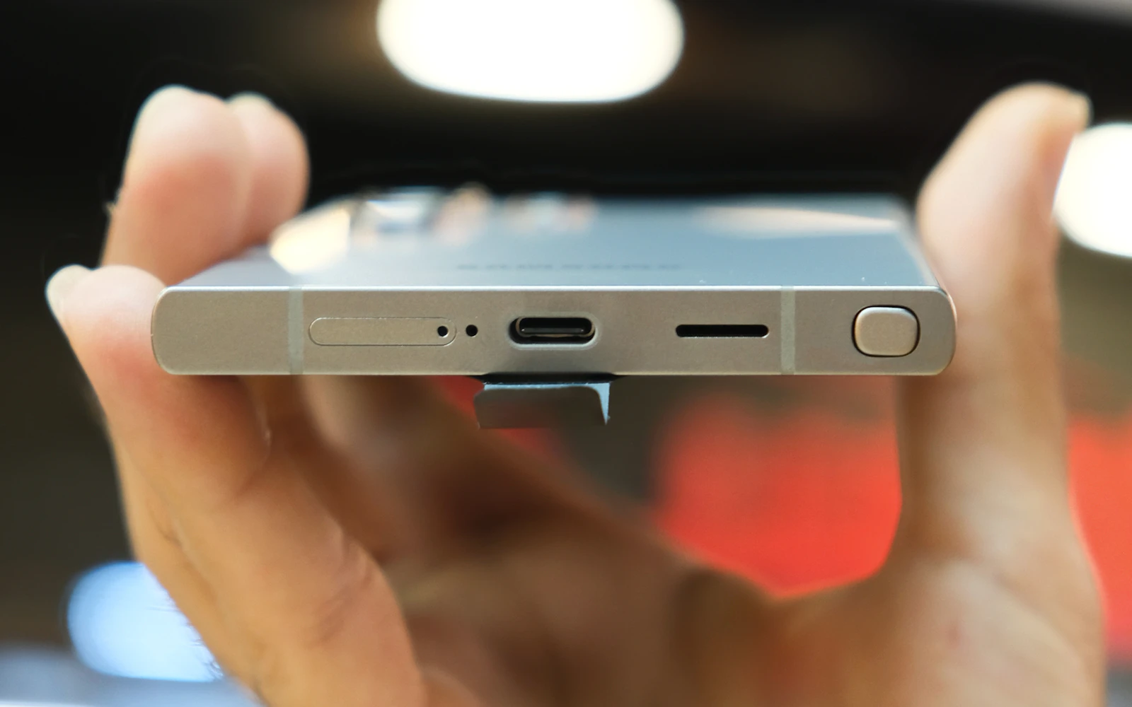 A hand holding a Samsung Galaxy S Ultra edge on, showing its USB-C port, speaker grille and S Pen slot