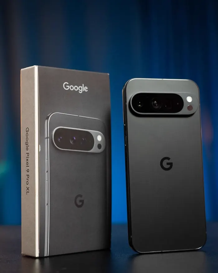 A Google Pixel Pro phone standing beside its retail box, its camera bar in view