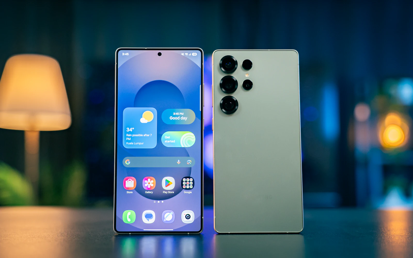Two Samsung Galaxy S Ultra phones standing side by side, one showing its One UI home screen and the other its rear cameras