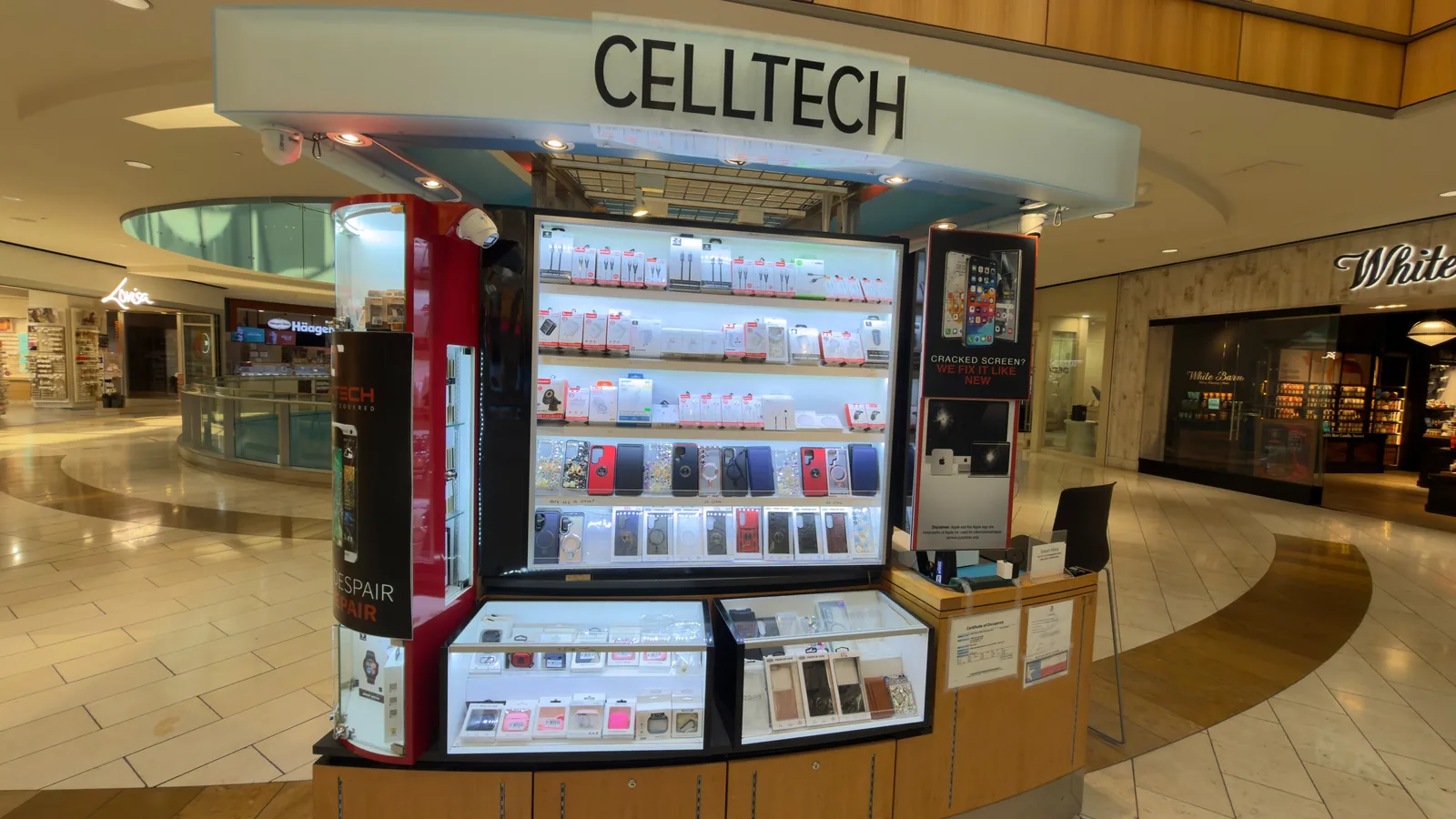 The CELLTECH kiosk on Level 2 of Galleria Dallas, seen head-on beneath the mall's glass barrel-vault roof